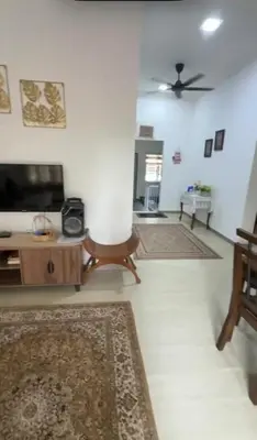 a living room with a couch and a tv at De Bagan Village, Tanjong Karang in Tanjung Karang