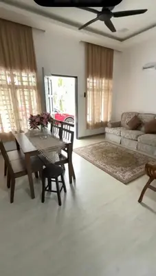 a living room with a table and a couch at De Bagan Village, Tanjong Karang in Tanjung Karang