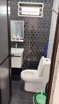a small bathroom with a toilet and a sink at De Bagan Village, Tanjong Karang in Tanjung Karang