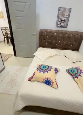 a bed with two pillows on top of it at De Bagan Village, Tanjong Karang in Tanjung Karang