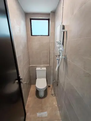 a small bathroom with a toilet and a window at Pets Friendly Hometstay at Georgetown Heritage in George Town