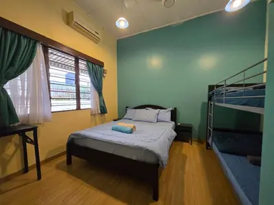 a bedroom with a bed and two bunk beds at House of Lights in Batu Gajah