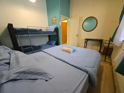 a bedroom with two bunk beds and a mirror at House of Lights in Batu Gajah