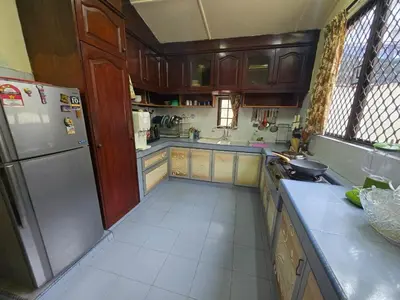 a kitchen with wooden cabinets and a stainless steel refrigerator at House of Lights in Batu Gajah
