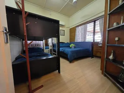 a room with two bunk beds and a bed at House of Lights in Batu Gajah