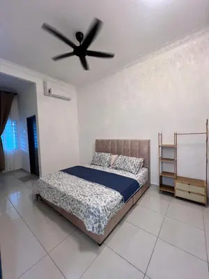 a bedroom with a bed and a ceiling fan at Homestay Yunaz in Kampong Banggol Pasir