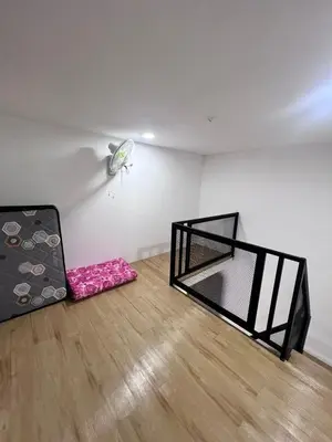 an empty room with two beds and a ceiling at Homestay Yunaz in Kampong Banggol Pasir