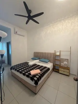 a bedroom with a bed with a ceiling fan at Homestay Yunaz in Kampong Banggol Pasir