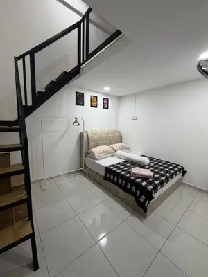 a bedroom with a bunk bed and a ladder at Homestay Yunaz in Kampong Banggol Pasir