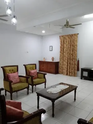 a living room with chairs and a coffee table at NORDIAZZ Home in Ipoh