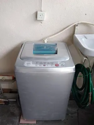 a washing machine sitting next to a sink at NORDIAZZ Home in Ipoh