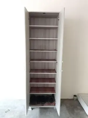 a cupboard with empty shelves in a room at NORDIAZZ Home in Ipoh