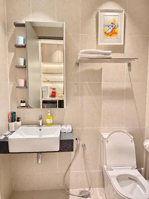 a bathroom with a sink and a toilet and a mirror at 22 Macalisterz - King Suite - 65
