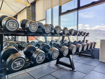 a row of dumbbells on display in a gym at 22 Macalisterz - King Suite - 65