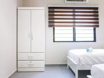 a bedroom with a dresser and a bed and a window at Cozy Corner PataniRoad 14 pax Georgetown in George Town
