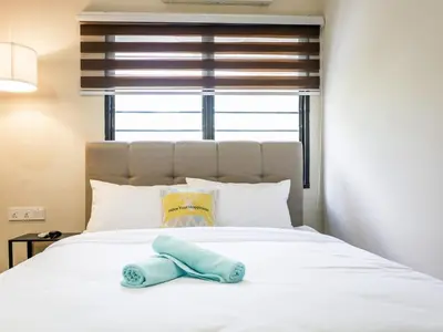 a stuffed animal sitting on top of a bed at Cozy Corner PataniRoad 14 pax Georgetown in George Town
