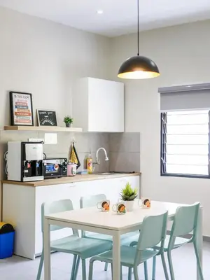 a kitchen with a table and chairs in a kitchen at Cozy Corner PataniRoad 14 pax Georgetown in George Town