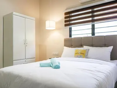 a bedroom with a large white bed with towels on it at Cozy Corner PataniRoad 14 pax Georgetown in George Town