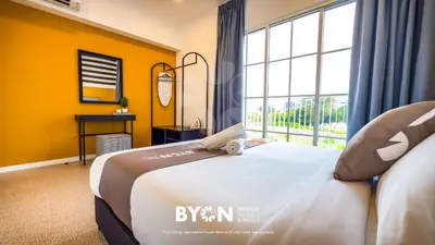 a bedroom with a large bed with a large window at The Stallionz Premium Suites Ipoh by BYON in Ipoh