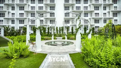 a building with a fountain in front of it at The Stallionz Premium Suites Ipoh by BYON in Ipoh