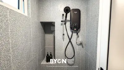 a bathroom with a shower with a hair dryer at The Stallionz Premium Suites Ipoh by BYON in Ipoh
