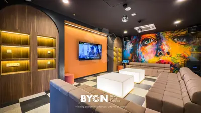 a room with a couch and a painting on the wall at The Stallionz Premium Suites Ipoh by BYON in Ipoh
