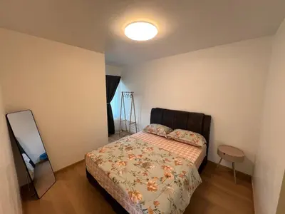 a small bedroom with a bed and a lamp at Rumah by Abg K in Cameron Highlands in Tanah Rata