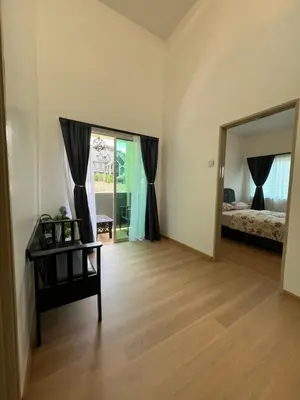 a room with a mirror and a bedroom with a bed at Rumah by Abg K in Cameron Highlands in Tanah Rata