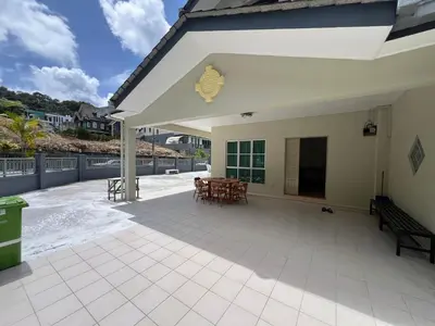 a large patio with tables and chairs on it at Rumah by Abg K in Cameron Highlands in Tanah Rata