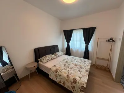 a bedroom with a bed and a window at Rumah by Abg K in Cameron Highlands in Tanah Rata