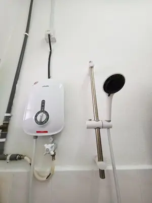 a white hair dryer and other tools in a bathroom at Homestay Taman Segar 23 for musleem in TanjongMalim
