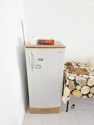 a small refrigerator with a box on top of it at Homestay Taman Segar 23 for musleem in TanjongMalim