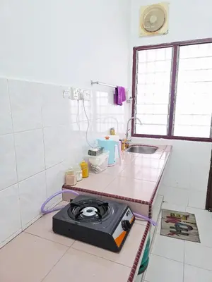 a kitchen with a stove on a counter in a room at Homestay Taman Segar 23 for musleem in TanjongMalim