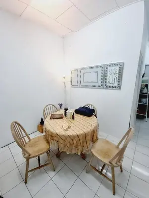 a dining room with a table and two chairs at Homestay Taman Segar for musleem in TanjongMalim
