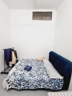 a bed in a room with a blue mattress at Homestay Taman Segar for musleem in TanjongMalim