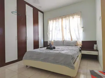 a bedroom with a large bed with a window at 10paxx HotSprings Recovery Stay in Ipoh