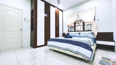 a bedroom with a large bed with a window at 10paxx HotSprings Recovery Stay in Ipoh