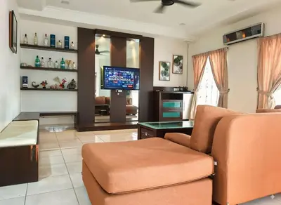 a living room with a couch and a tv at 10paxx HotSprings Recovery Stay in Ipoh