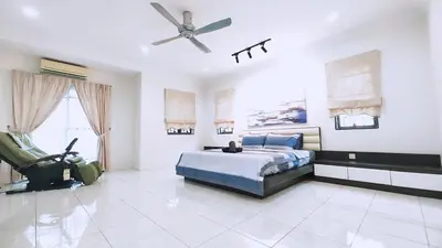 a bedroom with a bed and a ceiling fan at 10paxx HotSprings Recovery Stay in Ipoh