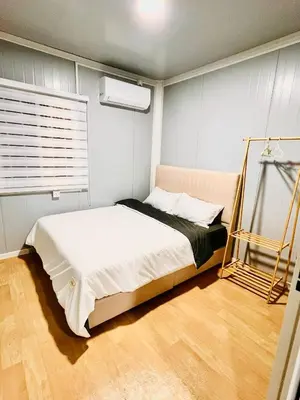 a bedroom with a bed in a room at Rossaliya Cottage in Taiping