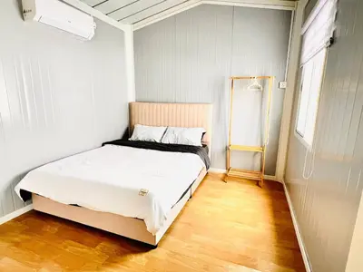 a bedroom with a bed in a small room at Rossaliya Cottage in Taiping