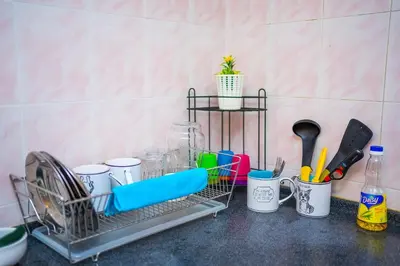 a dish drying rack with dishes and utensils on a counter at Spacious 4BR Corner with Pool Table in Ipoh