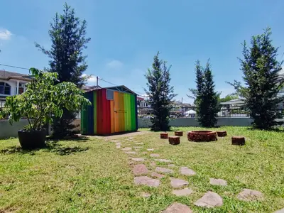 a colorful building in a yard with trees at Spacious 4BR Corner with Pool Table in Ipoh