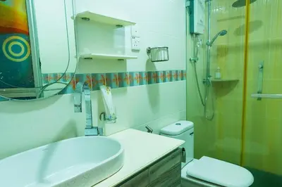 a bathroom with a sink and a shower and a toilet at Spacious 4BR Corner with Pool Table in Ipoh