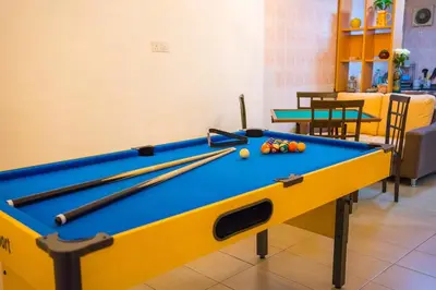 a pool table with balls on it in a room at Spacious 4BR Corner with Pool Table in Ipoh