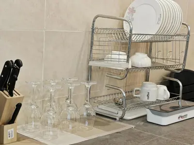 a kitchen counter with wine glasses and a drying rack at 16 Paxx Mountain Joy Corner Villa with KTV Pool BBQ in Ipoh