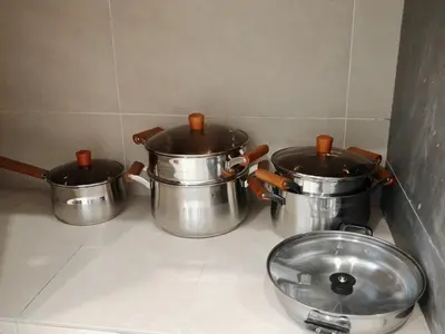 three pots and a bowl on a kitchen counter at 16 Paxx Mountain Joy Corner Villa with KTV Pool BBQ in Ipoh