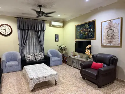 a living room with two chairs and a tv at Bidor Bonda Homestay in Bidur