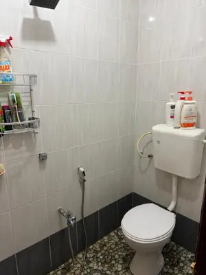 a bathroom with a white toilet in a room at Bidor Bonda Homestay in Bidur