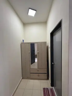 a bathroom with a cabinet with a mirror and a door at A&M Homestay Prima Bagan Serai in Bagan Serai